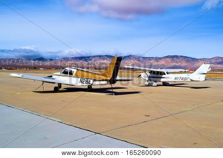 January 12, 2017 in Mojave, CA:  Small single engine turboprop planes parked on the tarmac at Mojave Airport where the public can fly and park their aircraft including flight lessons taken in Mojave, CA