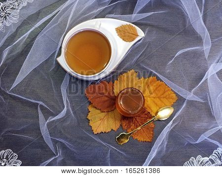 Cup of tea with honey on the table