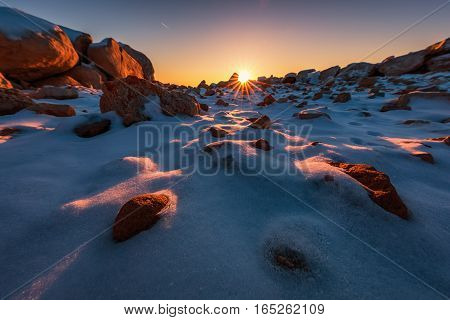Early morning with snow covered stones sunrsie shot