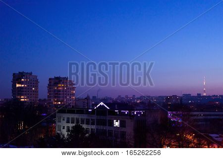 Chisinau city in the evening with a purple sunset, view on tv station and crown plazza buildings in centre