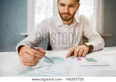 Business person analyzing financial statistics displayed on the tablet