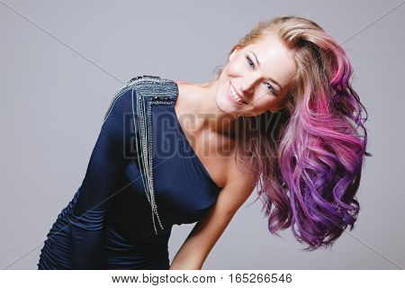 Colored hairstyle. Portrait of smiling women with big blue eyes. Ombre. Gradient. Studio