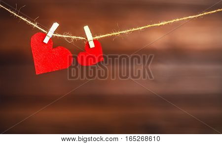 background Valentine's day. two red hearts on a wooden background