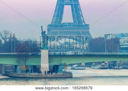 Statue of Liberty on the swan island in Paris at sunset. France.