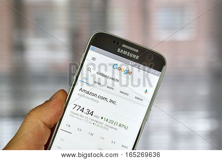 MONTREAL CANADA - DECEMBER 23 2016 : Google Finance page with stock chart and Amazon ticker on Samsung S7 screen.