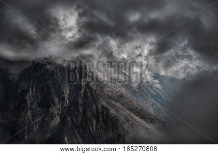 High mountains in clouds - rocky background. Nepal, Manaslu