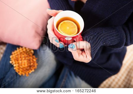 Holding Coffee Latte Cup with Cocoa Shape and Cozy Wool Hands Warmers on Magic Winter Background.