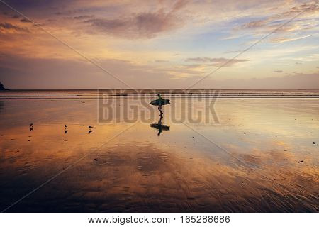 Beautiful sunset on the beach at low tide and reflections in the sand