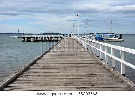 Rhyll Australia - December 29 2016. Old wood bridge pier at Rhyll (Philip Island Victoria Australia). Old wooden jetty with natural background.