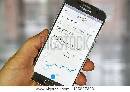 MONTREAL CANADA - DECEMBER 23 2016 : Google Finance page with stock chart and s p 500 index on Samsung S7 screen.