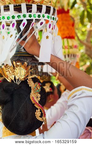 Group of beautiful Balinese women in costumes - sarong carry offering for Hindu ceremony. Traditional dances arts festivals culture of Bali island and Indonesia people. Indonesian travel background