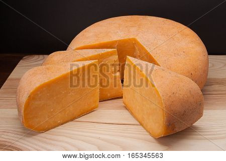Sliced piece of cheese on a wooden table