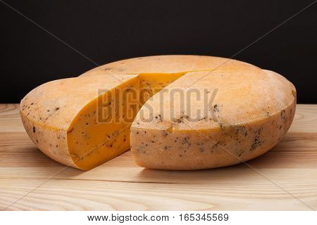 Sliced piece of cheese on a wooden table