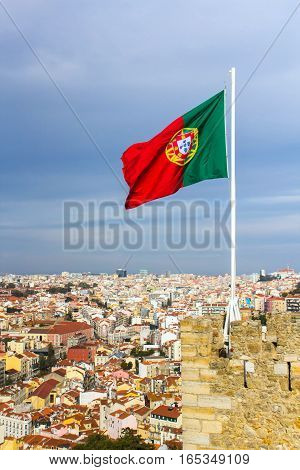 Waving portuguese flag on top of Saint Jorge Castle in Lisbon, Portugal