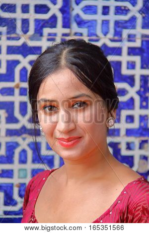 KHIVA, UZBEKISTAN - MAY 4, 2011: Portrait of a beautiful Uzbek young woman at Tosh Hovli palace