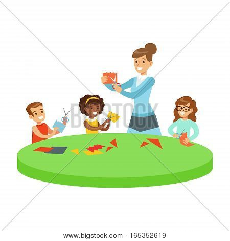 Three Children In Art Class Crafting Applique Cartoon Illustration With Elementary School Kids And Their Teacher In Creativity Lesson. Happy Schoolkids Doing Paper Craft With Demonstration From Adult Woman.