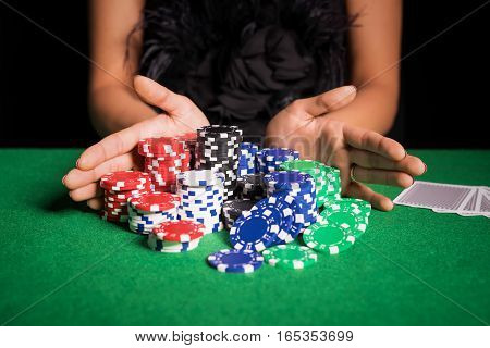 Woman playing poker with all in gesture