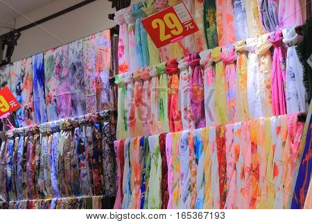 BEIJING CHINA - OCTOBER 29, 2016: Chinese silk shop on Nanluoguxiang futong street. Nanluoguxiang lane has become a popular tourist destination with restaurants and bars.