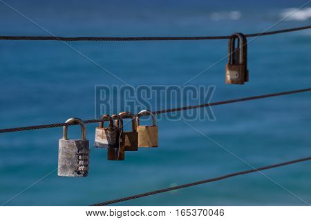 Closed padlocks on iron rope represent love and security