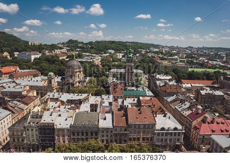 Town and sky at daytime. Green trees and buildings. Townscape in summer.