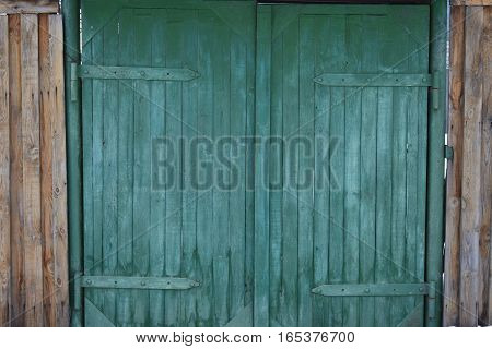 THE WOODEN GATE IS PLANTED ON A METAL LOOP
