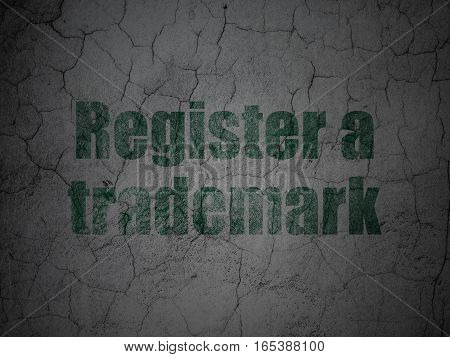 Law concept: Green Register A Trademark on grunge textured concrete wall background