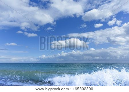 Beautiful sea paradise beach on a background of blue sky with clouds.