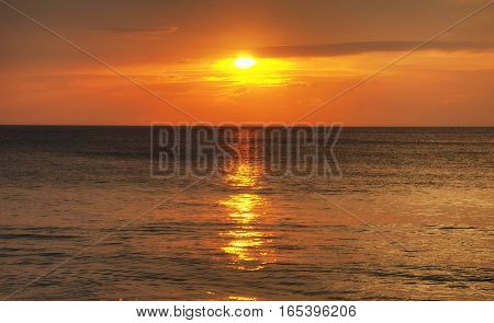 The sands of Mai khao beach in Talang city on Phuket Island thailand overlooking the andaman sea at sunset.