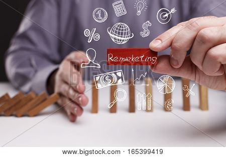 Business, Technology, Internet And Network Concept. Young Businessman Shows The Word: Remarketing