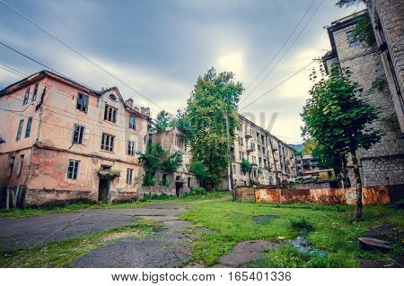 Abandoned mining ghost-town Jantuha, Abkhazia. Destroyed empty houses, the remains of the cars, remnant of The Georgian-Abkhazian war