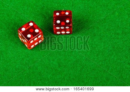 Gambling dice on a card table showing double 4
