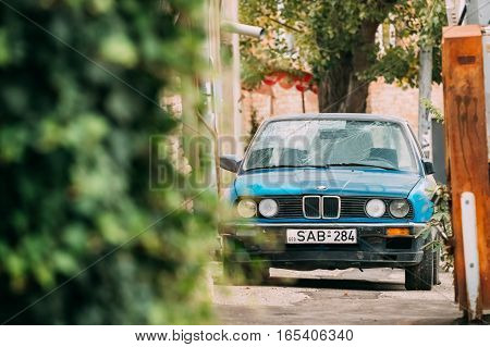 Tbilisi, Georgia - October 21, 2016: Old damaged rusty sedan car BMW 3 Series, E30, parking on street. The BMW E30 is an entry-level luxury car which was produced by BMW from 1982 to 1994.