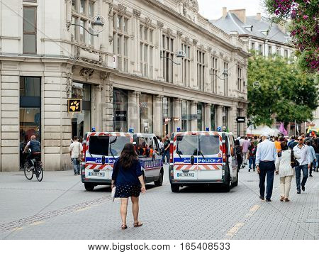 STRASBOURG FRANCE - SEP 12 2015: Police van surveillance of large group of Kurdish community wave flags and banners of convicted Kurdistan Worker's Party (PKK) leader Abdullah Ocalan during a demonstration calling for Ocalan's release in Strasbourg