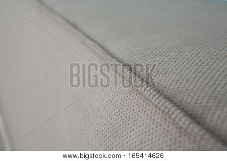 Grey colored mattress of bed in bedroom represented on hotel room. Mattress of bed in bedroom. Texture of mattress with no pattern and pictures.