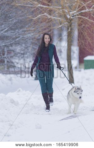 Pretty Smiling Woman Walking with Her Dog Outside. Vertical Image Composition