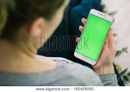 Beautiful girl holding a smartphone in the hands of a green screen green screen, hand of man holding mobile smart phone with chroma key green screen on white background, new technology concept