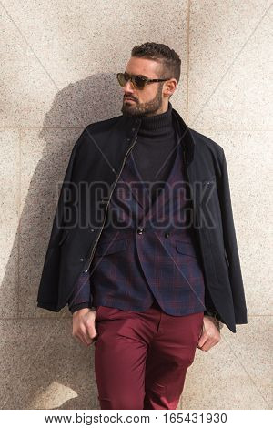 MILAN ITALY - JANUARY 14: Fashionable man poses outside Antonio Marras fashion show building during Milan Men's Fashion Week on JANUARY 14 2017 in Milan.
