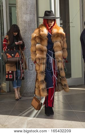 MILAN ITALY - JANUARY 14: Fashionable man poses outside Antonio Marras fashion show building during Milan Men's Fashion Week on JANUARY 14 2017 in Milan.