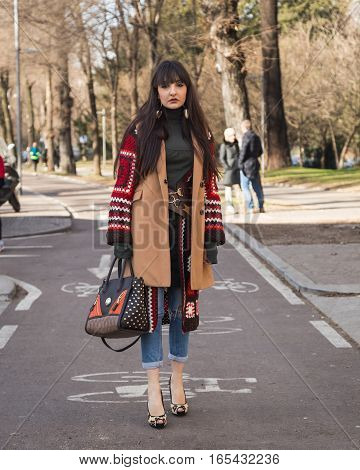 MILAN ITALY - JANUARY 14: Fashionable woman poses outside Antonio Marras fashion show building during Milan Men's Fashion Week on JANUARY 14 2017 in Milan.