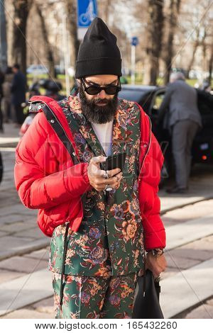 MILAN ITALY - JANUARY 14: Fashionable man poses outside Antonio Marras fashion show building during Milan Men's Fashion Week on JANUARY 14 2017 in Milan.