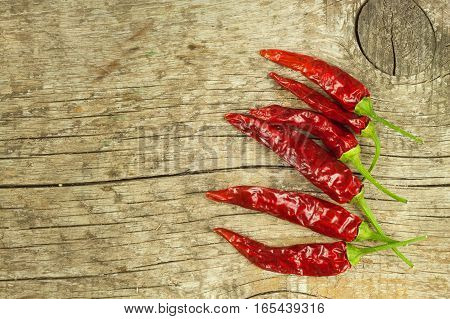 Dried Chili Peppers On Old Wooden Background. Sale Of Spices. Preparing Spicy Food. Place For Your T