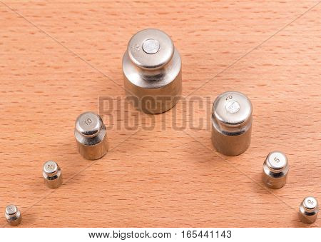 these metal weights are put on manual scales to counterbalance a subject on the other hand