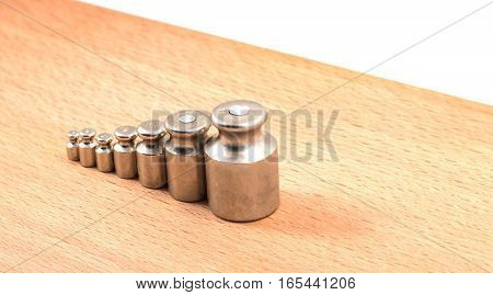 these metal weights are put on manual scales to counterbalance a subject on the other hand