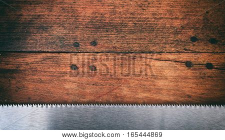 Hand Saw Blade On Wooden Background