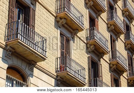 Rows of windows, balconies and wrought iron balusters in Barcelona, Catalonia, Spain