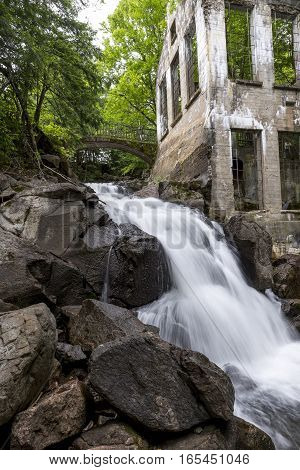 Ruins next to a waterfall in the a forest summer