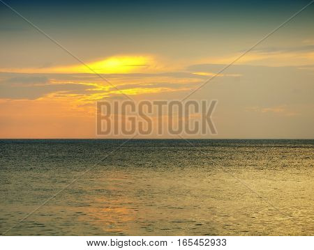 The sands of Mai khao beach in Talang city on Phuket Island thailand overlooking the andaman sea at sunset.