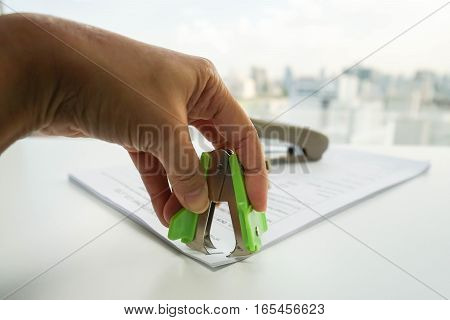 close up woman pull staple from business documents by staple remover