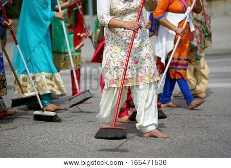 Many Barefoot Women Sweep The Road During The Ceremony Along The