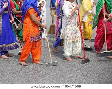 Barefoot Women  Sweep The Road During The Celebration Along The
